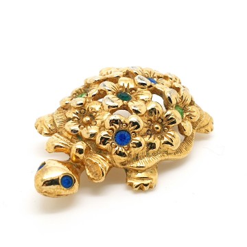 Avon - goldtone turtle brooch with flowered back and multicoloured rhinestones - Bliinkt