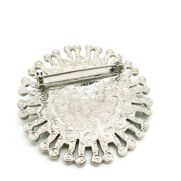 Broche 1928 zilverkleurig met blauwe en heldere strass achterzijde