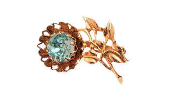 Broche. Goudkleurige bloem met een grote heldere babyblauw turquoise glasssteen 50's 60's
