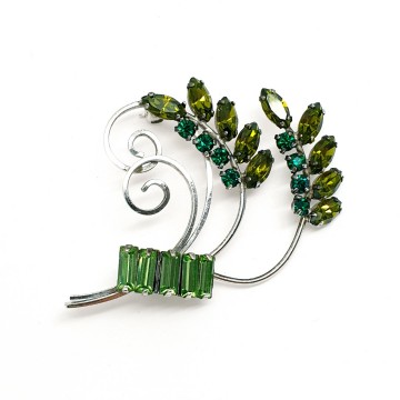 CC sterling brooch with green rhinestones