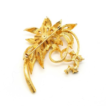 Classic goldtone flower brooch with blue and clear rhinestones