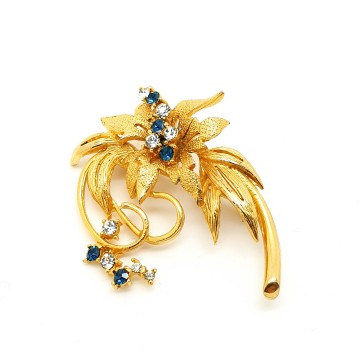 Classic goldtone flower brooch with blue and clear rhinestones