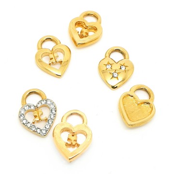 Courrèges Paris - goldtone hoop earrings with interchangeable hearts with logo - Bliinkt