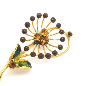 Delicate goldtone flower brooch with enamel leaves and amber coloured rhinestones - Bliinkt