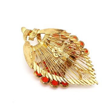 Goldtone butterfly sitting on wired leaf with red rhinestone wings - brooch