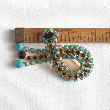 Goldtone dangle brooch with black and turquoise rhinestones