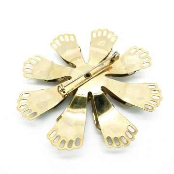 Goldtone flower brooch with black red and white enamelled leaves