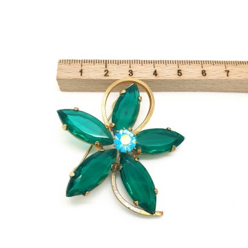 Goldtone flower brooch with unfoiled emerald green navette shaped glass stones and ab rhinestone 40s - Bliinkt