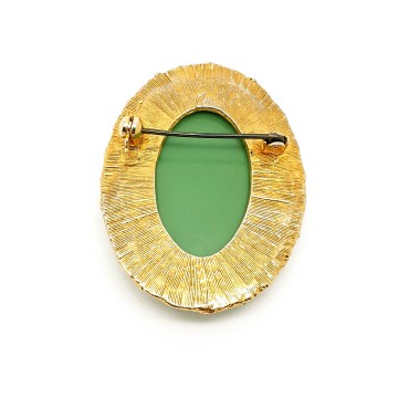 Goldtone oval brooch with green cameo