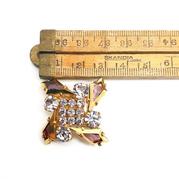 Bijzondere kleine goudkleurige broche met paarse strass - Bliinkt