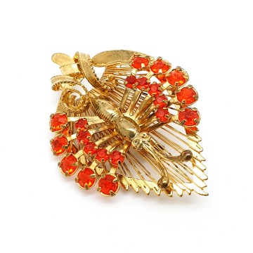 Goldtone butterfly sitting on wired leaf with red rhinestone wings - brooch