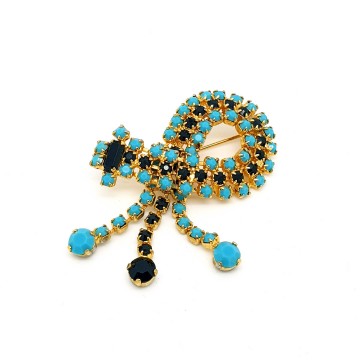 Goldtone dangle brooch with black and turquoise rhinestones