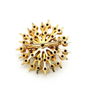 Goldtone snowflake brooch with clear green and soft yellow rhinestones