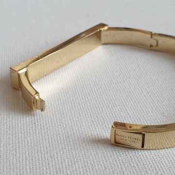 Henri Bendel New York goldtone bangle with black enamel and reversed rhinestones