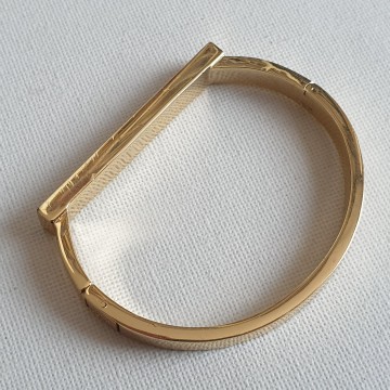 Henri Bendel New York goldtone bangle with black enamel and reversed rhinestones