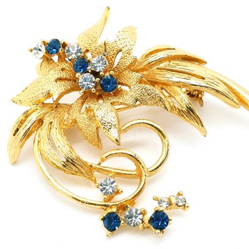 Classic goldtone flower brooch with blue and clear rhinestones