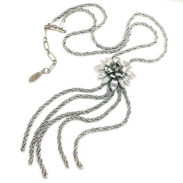 Long silvertone rope necklace with a floral centerpiece and multiple rope chain tassels - Bliinkt