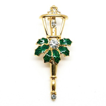 Monet - goldtone lantern brooch with clear strass and green enamel