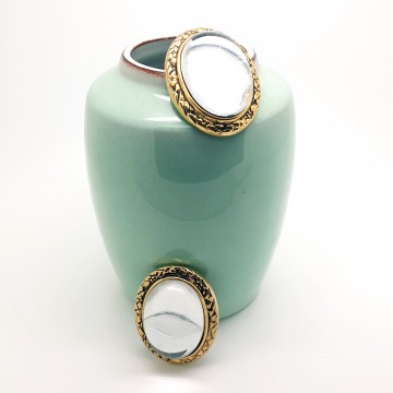 Oval domed transparant glass earrings with goldtone edge - Bliinkt