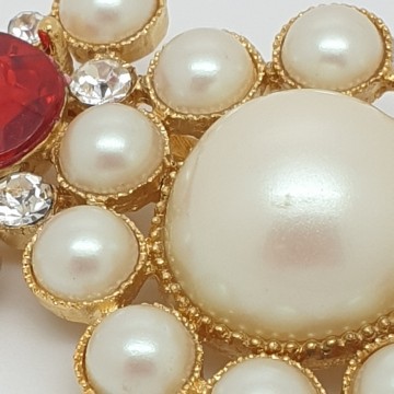 Richelieu goldtone brooch with red teardrop shaped rhinestones and faux pearls close up