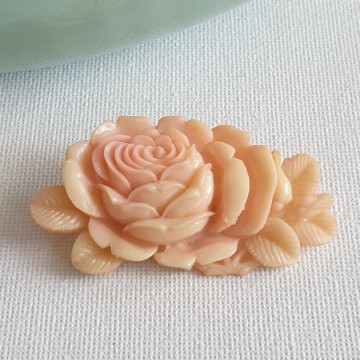 Peach coloured plastic rose brooch