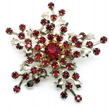 Silvertone snowflake brooch with red rhinestones