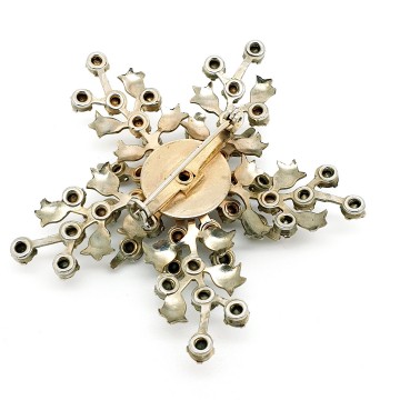 Silvertone snowflake brooch with red rhinestones