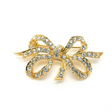 Sphinx - goldtone bow brooch with clear rhinestones - Bliinkt
