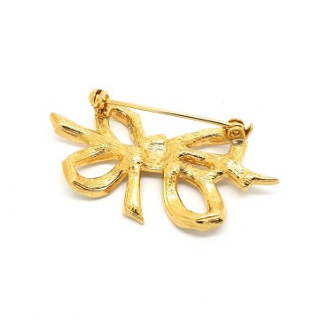 Sphinx - goldtone bow brooch with clear rhinestones - Bliinkt