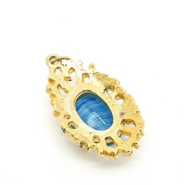 Sphinx goldtone pendant with blue faceted glass stone