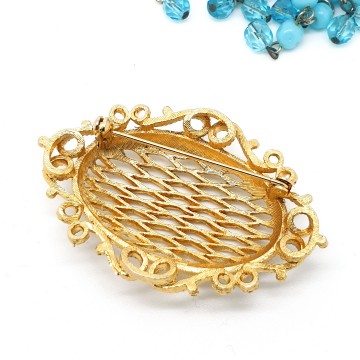 Opengewerkte goudkleurige broche