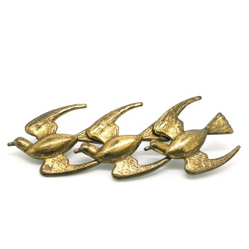 Three brass birds in flight - Bliinkt