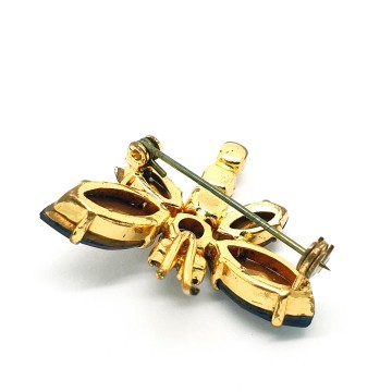 Tiny insect brooch with champaign coloured body brown rhinestone wings and red eyes and   bliinkt