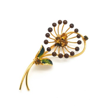Delicate goldtone flower brooch with enamel leaves and amber coloured rhinestones - Bliinkt